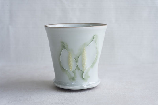 Pale celadon cup with floral motif