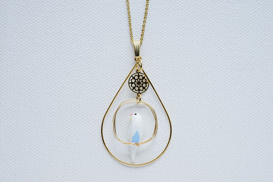 One-Horned Budgie (White) Pendant with Surrounding Accessoires