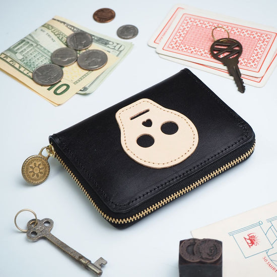 Compact Wallet with Round Zipper Closure in Black Cowhide Leather with Skull Patchwork