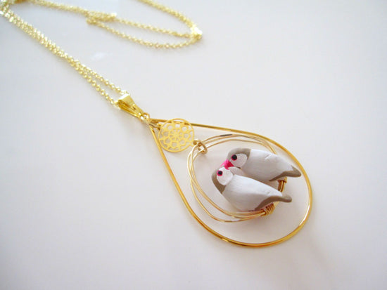 Pendant with Two Cinnamon Bunting with Surrounding Accessoires