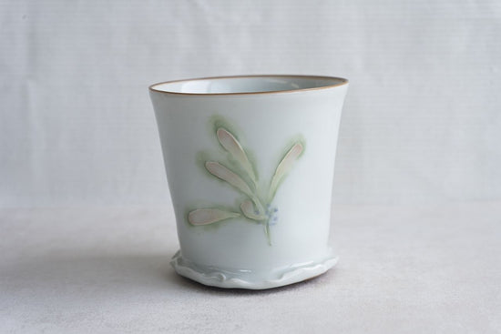Pale celadon cup with floral motif