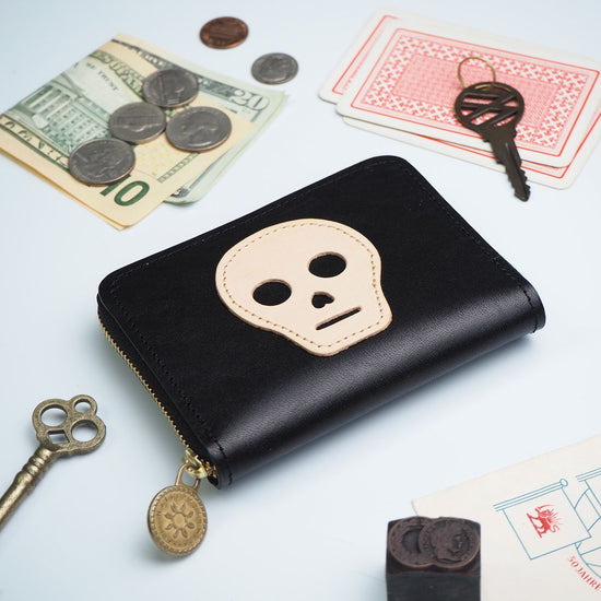 Compact Wallet with Round Zipper Closure in Black Cowhide Leather with Skull Patchwork