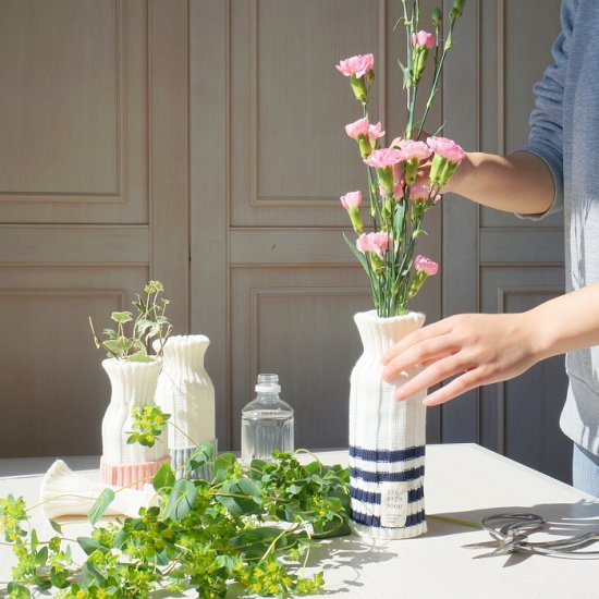 Wrap flowers in knit plastic bottles as vases